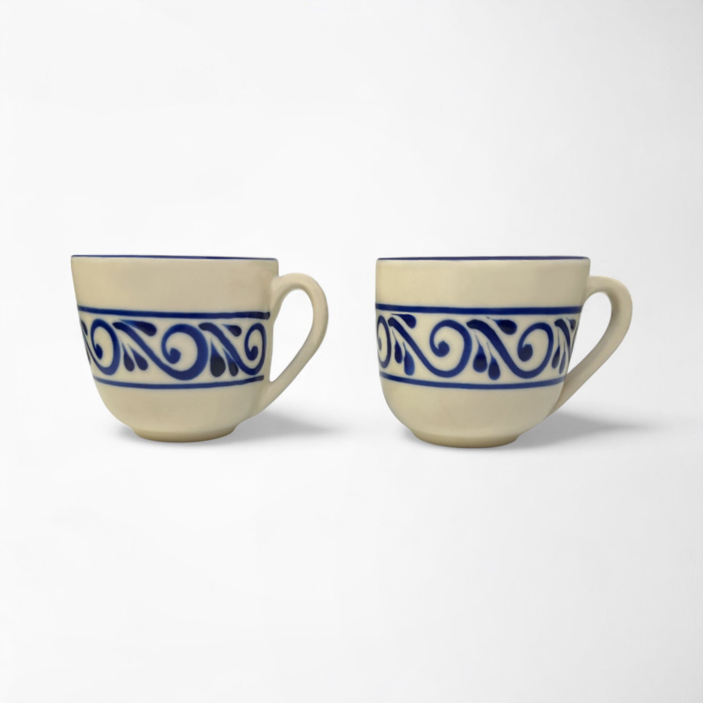 Pair of handcrafted mugs in matching designs, ideal for coffee lovers or home décor enthusiasts.