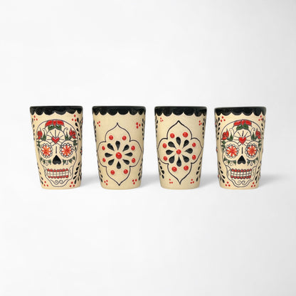 Four ceramic tequila shooters with day of the dead sugar skull designs 